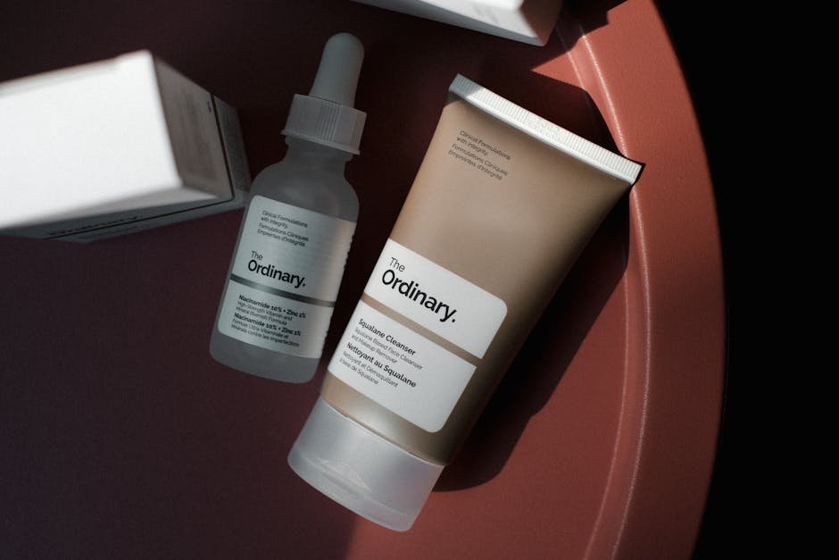 Chic minimalist shot of The Ordinary skincare products on a rose-colored background.