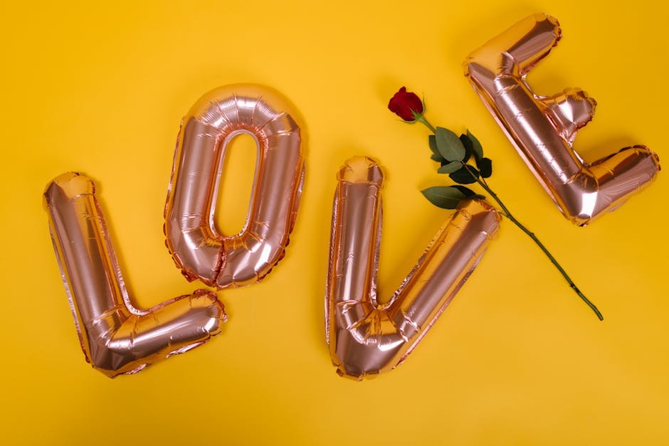 Valentine's Day theme with love balloons and red rose on a yellow background.