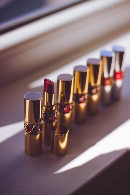 A stylish display of red lipsticks in gold tubes, capturing a chic and elegant look.